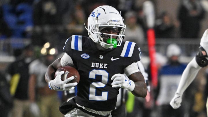 Nov 29, 2025; Durham, North Carolina, USA;  Duke Blue Devils wide receiver Sahmir Hagans (2) runs the ball against Wake Forest Demon Deacons linebacker Whittman Whaley (40) during the fourth quarter at Wallace Wade Stadium. Mandatory Credit: Zachary Taft-Imagn Images