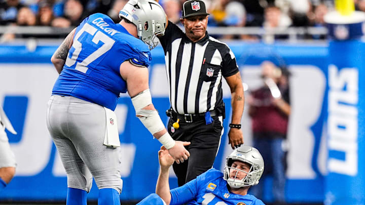Detroit Lions center Trystan Colon (57) picks up quarterback Jared Goff (16) after a play against Green Bay Packers