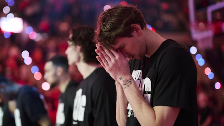 Jan 19, 2025; Portland, Oregon, USA; Chicago Bulls forward Matas Buzelis (14) pauses during a silent reflection during the singing of the national anthem before a game against the Portland Trail Blazers at Moda Center. Mandatory Credit: Troy Wayrynen-Imagn Images Jan 19, 2025; Portland, Oregon, USA; Chicago Bulls forward Matas Buzelis (14) pauses during a silent reflection during the singing of the national anthem before a game against the Portland Trail Blazers at Moda Center. Mandatory Credit: Troy Wayrynen-Imagn Images