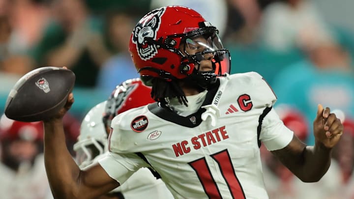 Nov 15, 2025; Miami Gardens, Florida, USA; NC State Wolfpack quarterback CJ Bailey (11) throws downfield against the Miami Hurricanes during the third quarter at Hard Rock Stadium. Mandatory Credit: Sam Navarro-Imagn Images