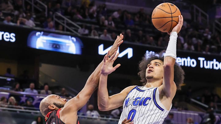 Dec 1, 2025; Orlando, Florida, USA; Orlando Magic guard Anthony Black (0) shoots against Chicago Bulls guard Jevon Carter (5) during the second quarter at Kia Center. Mandatory Credit: Mike Watters-Imagn Images