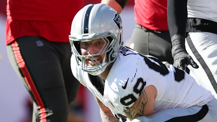 Dec 8, 2024; Tampa, Florida, USA; Las Vegas Raiders defensive end Maxx Crosby (98) sacks Tampa Bay Buccaneers quarterback Baker Mayfield (6) in the second quarter at Raymond James Stadium. Mandatory Credit: Nathan Ray Seebeck-Imagn Images