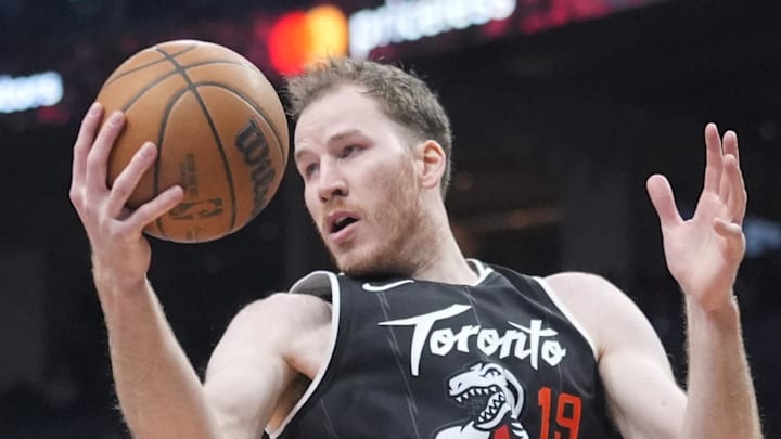 Toronto Raptors center Jakob Poeltl gets control of a rebound against the Boston Celtics.