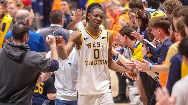 Mar 6, 2026; Morgantown, West Virginia, USA; West Virginia Mountaineers forward Brenen Lorient (0) celebrates with fans after defeating the UCF Knights at Hope Coliseum. Mandatory Credit: Ben Queen-Imagn Images