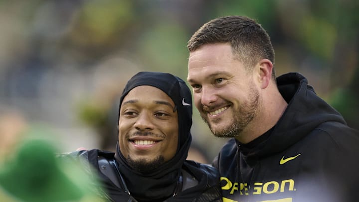 Nov 30, 2024; Eugene, Oregon, USA; Oregon Ducks head coach Dan Lanning celebrates with wide receiver Tez Johnson (15) during a senior recognition ceremony before a game against the Washington Huskies at Autzen Stadium. Mandatory Credit: Troy Wayrynen-Imagn Images