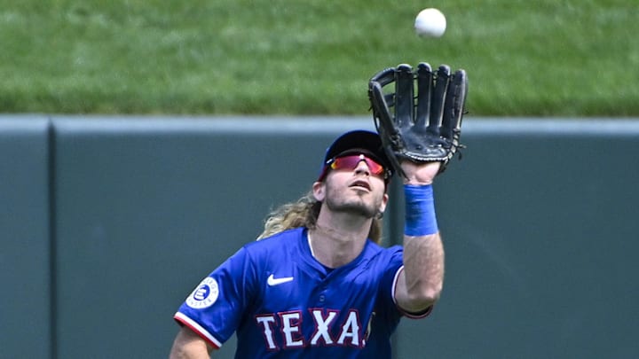 Jul 31, 2024; St. Louis, Missouri, USA;  Texas Rangers center fielder Travis Jankowski (16) catches a fly ball against the St. Louis Cardinals during the third inning at Busch Stadium
