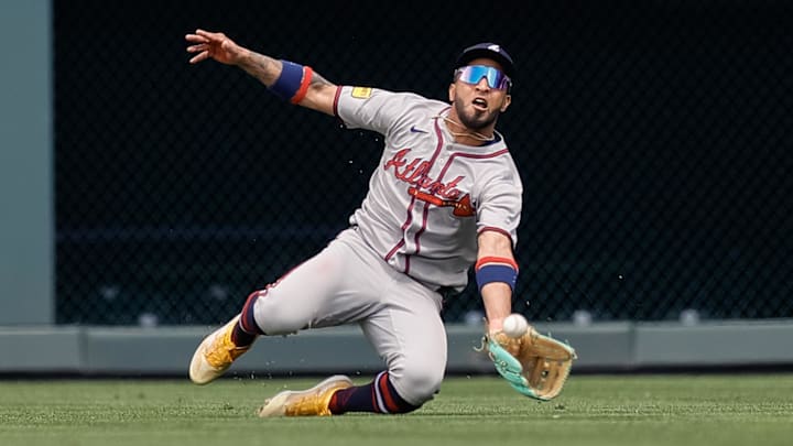 Apr 30, 2025; Denver, Colorado, USA; Atlanta Braves right field Eddie Rosario (9) makes a catch for an out in the third inning against the Colorado Rockies at Coors Field. Mandatory Credit: Isaiah J. Downing-Imagn Images