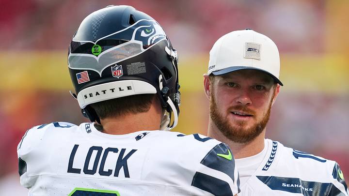 Seattle Seahawks quarterback Sam Darnold talks with quarterback Drew Lock