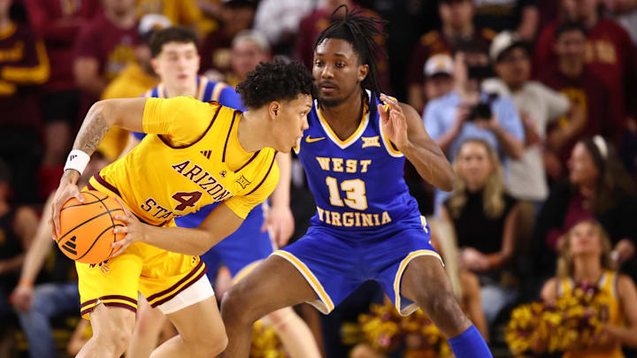 Jan 21, 2026; Tempe, Arizona, USA; Arizona State Sun Devils guard Bryce Ford (4) controls the ball against West Virginia Mountaineers guard Chance Moore (13) in the first half at Desert Financial Arena. Mandatory Credit: Mark J. Rebilas-Imagn Images Jan 21, 2026; Tempe, Arizona, USA; Arizona State Sun Devils guard Bryce Ford (4) controls the ball against West Virginia Mountaineers guard Chance Moore (13) in the first half at Desert Financial Arena. Mandatory Credit: Mark J. Rebilas-Imagn Images