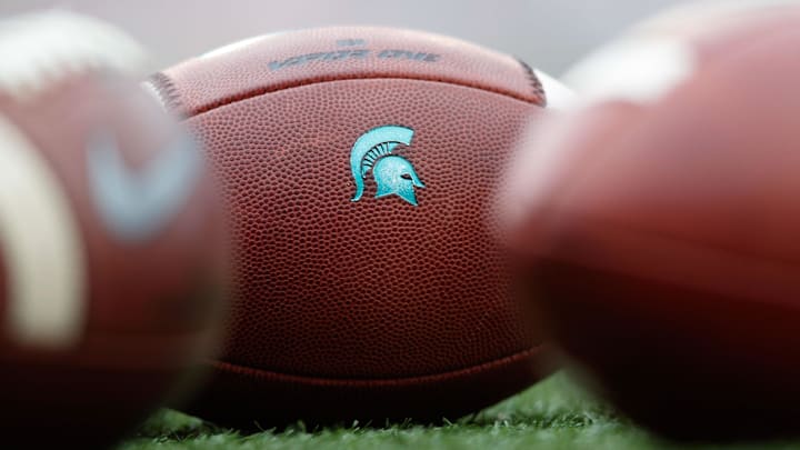 Oct 12, 2019; Madison, WI, USA; Michigan State Spartans logo on footballs during warmups prior to the game against the Wisconsin Badgers at Camp Randall Stadium. Mandatory Credit: Jeff Hanisch-Imagn Images Oct 12, 2019; Madison, WI, USA; Michigan State Spartans logo on footballs during warmups prior to the game against the Wisconsin Badgers at Camp Randall Stadium. Mandatory Credit: Jeff Hanisch-Imagn Images