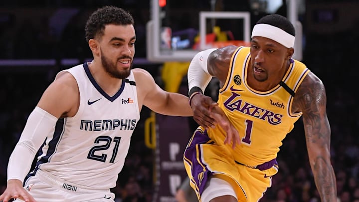 Feb 21, 2020; Los Angeles, California, USA;  Memphis Grizzlies guard Tyus Jones (21) drives against Los Angeles Lakers guard Kentavious Caldwell-Pope (1) during the third quarter at Staples Center. Mandatory Credit: Robert Hanashiro-Imagn Images