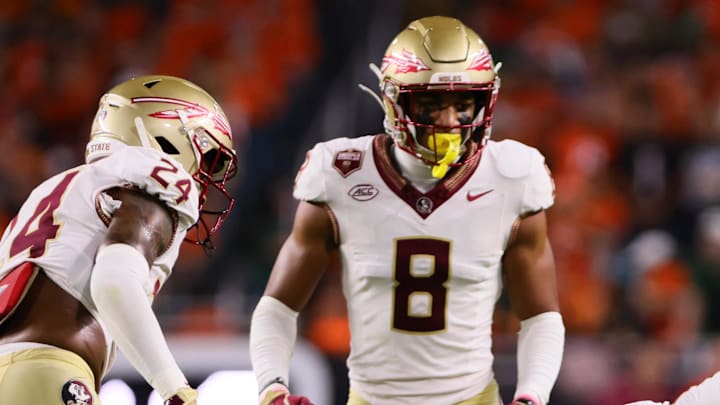 Oct 26, 2024; Miami Gardens, Florida, USA; Florida State Seminoles defensive lineman KJ Sampson (56) tackles Miami Hurricanes wide receiver Samuel Brown (11) during the third quarter at Hard Rock Stadium. Mandatory Credit: Sam Navarro-Imagn Images