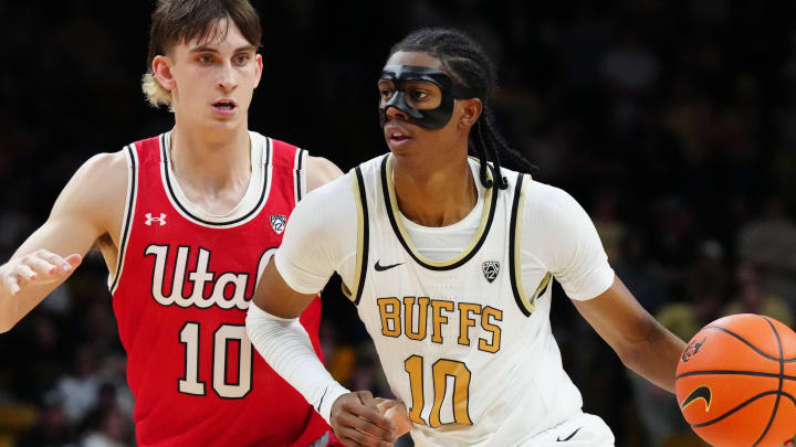 Feb 24, 2024; Boulder, Colorado, USA; Colorado Buffaloes forward Cody Williams (10) drives past Utah Utes forward Jake Wahlin (10) in the second half at the CU Events Center. Mandatory Credit: Ron Chenoy-USA TODAY Sports
