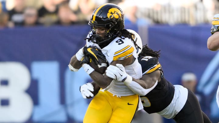 Dec 30, 2024; Nashville, TN, USA; Iowa Hawkeye running back Jaziun Patterson (9) gets tackled from behind by Missouri Tigers defensive end Johnny Walker Jr. (15) during the first half at Nissan Stadium. Mandatory Credit: Steve Roberts-Imagn Images Dec 30, 2024; Nashville, TN, USA; Iowa Hawkeye running back Jaziun Patterson (9) gets tackled from behind by Missouri Tigers defensive end Johnny Walker Jr. (15) during the first half at Nissan Stadium. Mandatory Credit: Steve Roberts-Imagn Images