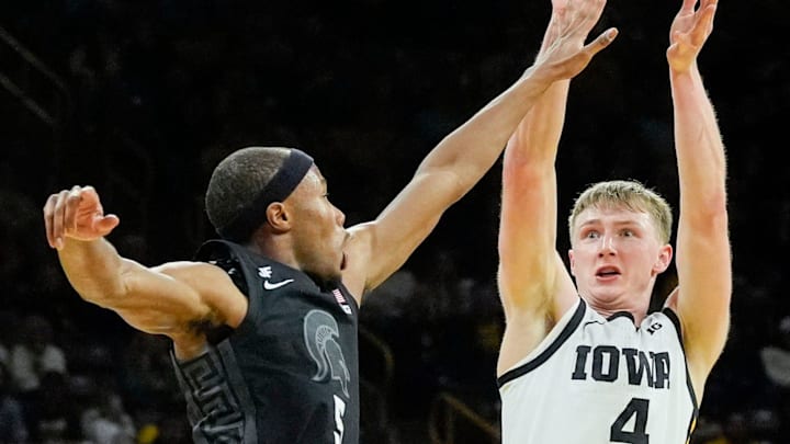 Iowa guard Josh Dix (4) attempts a 3 as Michigan State guard Tre Holloman (5) defends during a Big Ten Conference game Thursday, March 6, 2025 at Carver-Hawkeye Arena in Iowa City. Iowa guard Josh Dix (4) attempts a 3 as Michigan State guard Tre Holloman (5) defends during a Big Ten Conference game Thursday, March 6, 2025 at Carver-Hawkeye Arena in Iowa City.