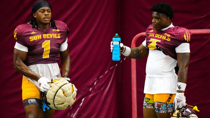 Arizona State running backs Kyson Brown (1) and Raleek Brown (3) take a water break during a practice inside the Verde Dickey Dome in Tempe on August 12, 2025.