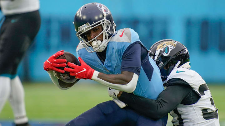 Tennessee Titans wide receiver Calvin Ridley (0) is stopped by Jacksonville Jaguars cornerback Montaric Brown (30) after a gain of four yards during the third quarter at Nissan Stadium in Nashville, Tenn., Sunday, Dec. 8, 2024.
