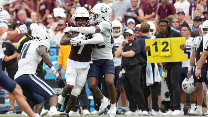 Sep 6, 2025; College Station, Texas, USA; Utah State Aggies cornerback Courage Ugo (22) tackles Texas A&M Aggies wide receiver KC Concepcion (7) during the first half against the Texas A&M Aggies at Kyle Field. Mandatory Credit: Sean Thomas-Imagn Images