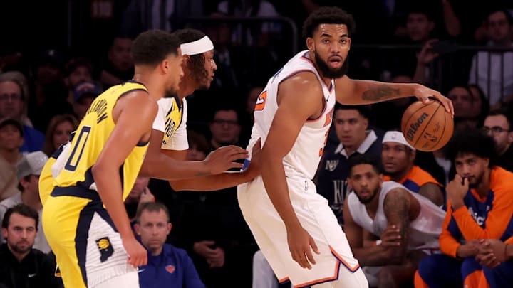 Oct 25, 2024; New York, New York, USA; New York Knicks center Karl-Anthony Towns (32) controls the ball against Indiana Pacers center Myles Turner (33) and guard Tyrese Haliburton (0) during the first quarter at Madison Square Garden. Mandatory Credit: Brad Penner-Imagn Images