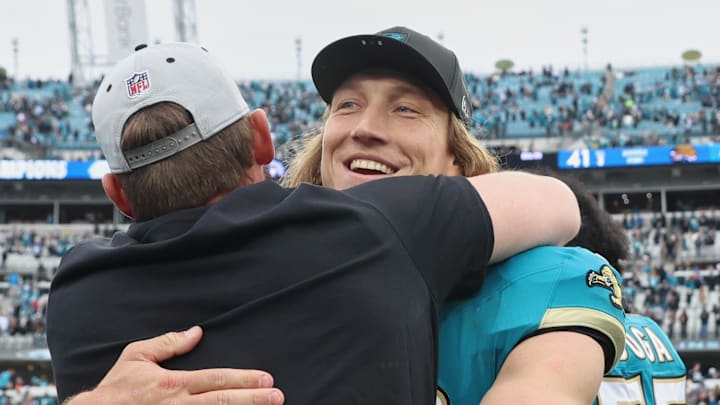 Jan 4, 2026; Jacksonville, Florida, USA; Jacksonville Jaguars quarterback Trevor Lawrence (16) celebrates with head coach Liam Coen (obscured) after the game against the Tennessee Titans at EverBank Stadium. 