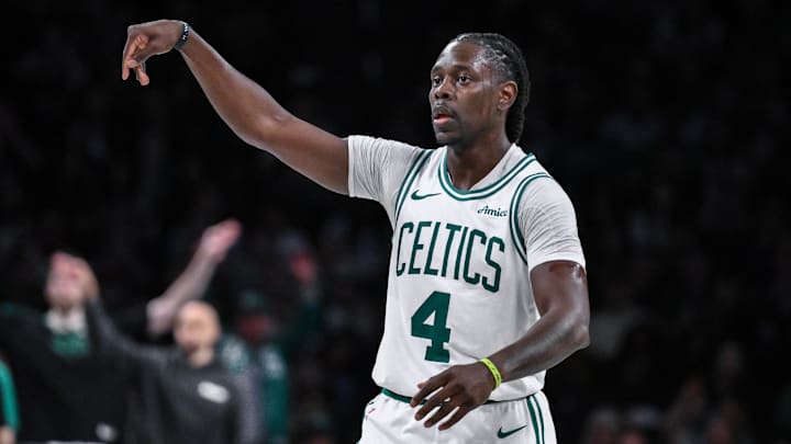 Boston Celtics guard Holiday reacts after making a three-point shot. 