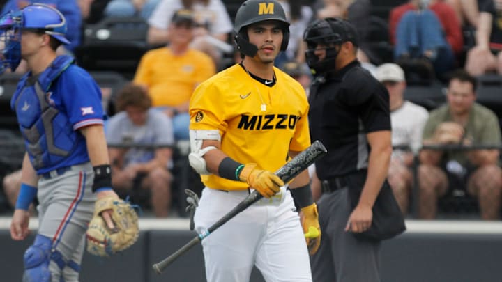 Catcher Mateo Serna heads back to the dugout against Kansas.