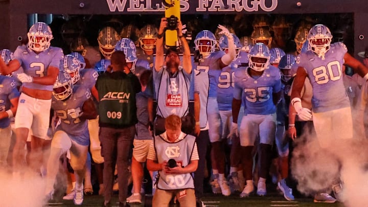 UNC entering Kenan Stadium through smoke before its game against TCU on Sept. 1, 2025.