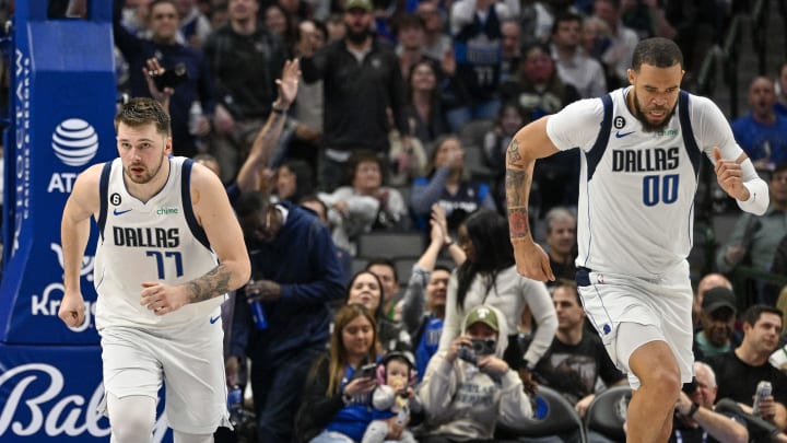 Jan 7, 2023; Dallas, Texas, USA; Dallas Mavericks guard Luka Doncic (77) and center JaVale McGee (00) run back up the court after McGee scores on an alley oop pass by Doncic against the New Orleans Pelicans during the second half at the American Airlines Center. Mandatory Credit: Jerome Miron-USA TODAY Sports