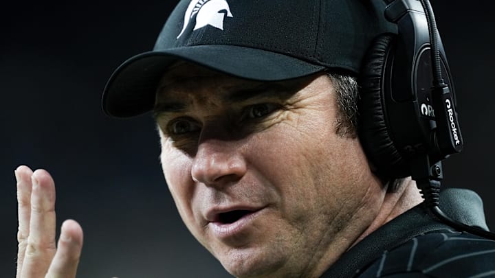 Nov 29, 2025; Detroit, Michigan, USA; Michigan State head coach Jonathan Smith asks a referee for the number of a penalized player in the first quarter at Ford Field. Mandatory Credit: Brendan Mullin-Imagn Images