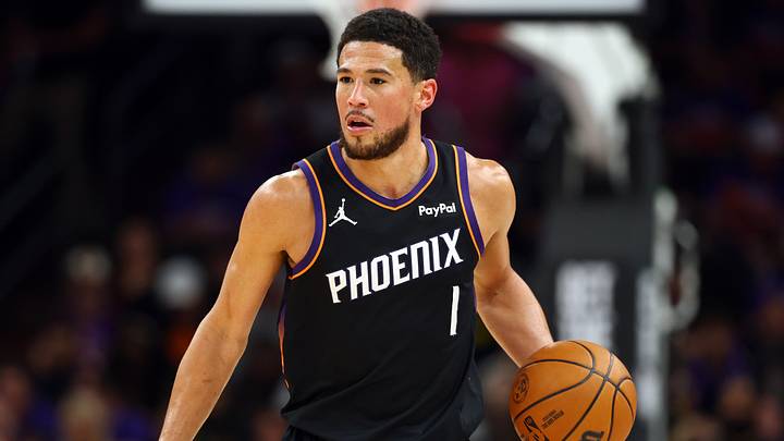 Apr 17, 2026; Phoenix, Arizona, USA; Phoenix Suns guard Devin Booker (1) against the Golden State Warriors during the play-in rounds of the 2026 NBA Playoffs at Mortgage Matchup Center. Mandatory Credit: Mark J. Rebilas-Imagn Images