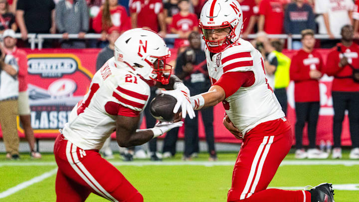 Dylan Raiola hands off to Emmett Johnson during the Huskers' season opener against Cincinnati.