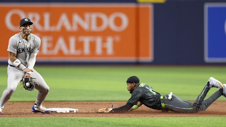 Apr 11, 2026; St. Petersburg, Florida, USA; Tampa Bay Rays left fielder Chandler Simpson (14) steals second from New York Yankees shortstop Jose Caballero (72) in the tenth inning at Tropicana Field. Mandatory Credit: Nathan Ray Seebeck-Imagn Images Apr 11, 2026; St. Petersburg, Florida, USA; Tampa Bay Rays left fielder Chandler Simpson (14) steals second from New York Yankees shortstop Jose Caballero (72) in the tenth inning at Tropicana Field. Mandatory Credit: Nathan Ray Seebeck-Imagn Images
