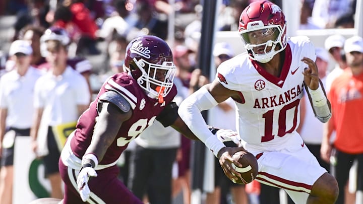 Arkansas Razorbacks quarterback Taylen Green (10) runs the ball while defended by Mississippi State Bulldogs defensive lineman Deonte Anderson (91) during the second quarter at Davis Wade Stadium at Scott Field.