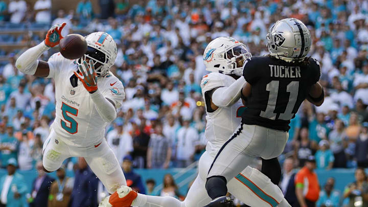 Nov 19, 2023; Miami Gardens, Florida, USA; Miami Dolphins cornerback Jalen Ramsey (5) intercepts a pass intended to Las Vegas Raiders wide receiver Tre Tucker (11) during the fourth quarter at Hard Rock Stadium. Mandatory Credit: Sam Navarro-Imagn Images