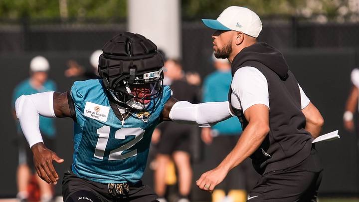 Jacksonville Jaguars Cornerback/Wide Receiver Travis Hunter (12) runs drills with Defensive Backs Coach Anthony Perkins during the Jacksonville Jaguars 10th day of NFL Training Camp at the Miller Electric Center in Jacksonville, Fla., Sunday, August 9, 2026.    [Doug Engle/Florida Times-Union]