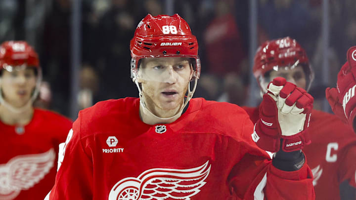 Mar 27, 2025; Detroit, Michigan, USA;  Detroit Red Wings right wing Patrick Kane (88) is congratulated by teammates after scoring in the third period against the Ottawa Senators at Little Caesars Arena. Mandatory Credit: Rick Osentoski-Imagn Images