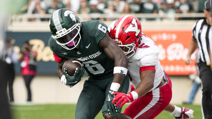 Sep 13, 2025; East Lansing, Michigan, USA; Youngstown State linebacker Carston Marshall (5) tackles Michigan State wide receiver Nick Marsh (6) in the second quarter at Spartan Stadium. Mandatory Credit: Brendan Mullin-Imagn Images