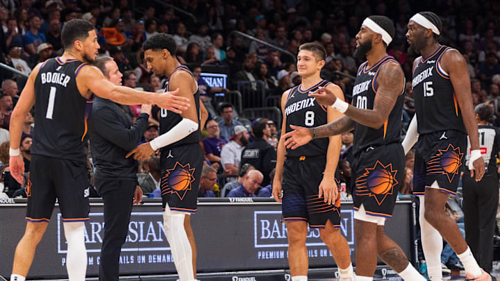 Nov 2, 2025; Phoenix, Arizona, USA; Phoenix Suns guard Devin Booker (1), forward Ryan Dunn (0), Coach Jordan Ott, guard Grayson Allen (8), forward Royce O'Neale (00) and center Mark Williams (15) celebrate during a time-out in the second half against the San Antonio Spurs at Mortgage Matchup Center. Mandatory Credit: Allan Henry-Imagn Images
