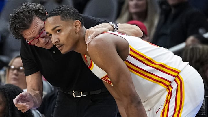 Atlanta Hawks head coach Quin Snyder talks to guard Kobe Bufkin (4) during the game against the Cleveland Cavaliers during the second half at State Farm Arena.