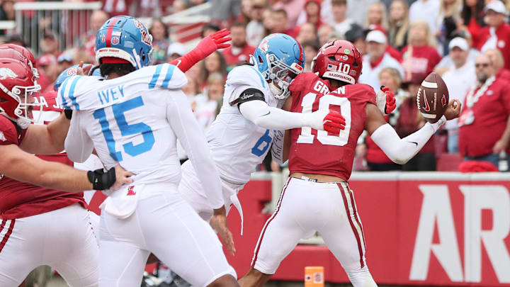 Nov 2, 2024; Fayetteville, Arkansas, USA; Arkansas Razorbacks quarterback Taylen Green (10) fumbles as he is hit by Ole Miss Rebels linebacker TJ Dottery (6) during the first quarter at Donald W. Reynolds Razorback Stadium. Mandatory Credit: Nelson Chenault-Imagn Images