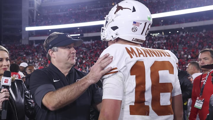Georgia Bulldogs head coach Kirby Smart and Texas Longhorns quarterback Arch Manning interact after a game at Sanford Stadium.