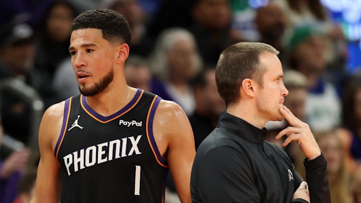 Nov 21, 2025; Phoenix, Arizona, USA; Phoenix Suns head coach Jordan Ott (left) with guard Devin Booker (1) against the Minnesota Timberwolves in the second half of an NBA Cup game at Mortgage Matchup Center. Mandatory Credit: Mark J. Rebilas-Imagn Images