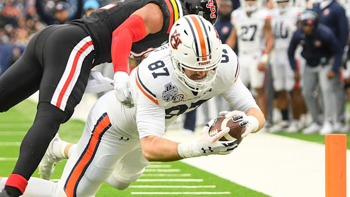 Dec 30, 2023; Nashville, TN, USA;  Auburn Tigers tight end Brandon Frazier (87) and Maryland Terrapins defensive back Beau Brade (2) during the first half at Nissan Stadium. Mandatory Credit: Steve Roberts-Imagn Images