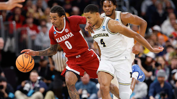Mar 27, 2026; Chicago, IL, USA; Alabama Crimson Tide guard Labaron Philon Jr. (0) dribbles while defended by Michigan Wolverines guard Nimari Burnett (4) in the first half during a Sweet Sixteen game of the Midwest Regional of the men's 2026 NCAA Tournament at United Center. Mandatory Credit: Kamil Krzaczynski-Imagn Images