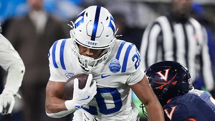 Dec 6, 2025; Charlotte, NC, USA; Duke Blue Devils running back Nate Sheppard (20) runs the ball while defended by Virginia Cavaliers cornerback Jam Jackson (9) in the first quarter during the 2025 ACC Championship game at Bank of America Stadium. Mandatory Credit: Jim Dedmon-Imagn Images Dec 6, 2025; Charlotte, NC, USA; Duke Blue Devils running back Nate Sheppard (20) runs the ball while defended by Virginia Cavaliers cornerback Jam Jackson (9) in the first quarter during the 2025 ACC Championship game at Bank of America Stadium. Mandatory Credit: Jim Dedmon-Imagn Images