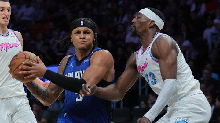 Jan 27, 2025; Miami, Florida, USA; Orlando Magic forward Paolo Banchero (5) drives to the basket against Miami Heat center Bam Adebayo (13) during the fourth quarter at Kaseya Center. Mandatory Credit: Sam Navarro-Imagn Images