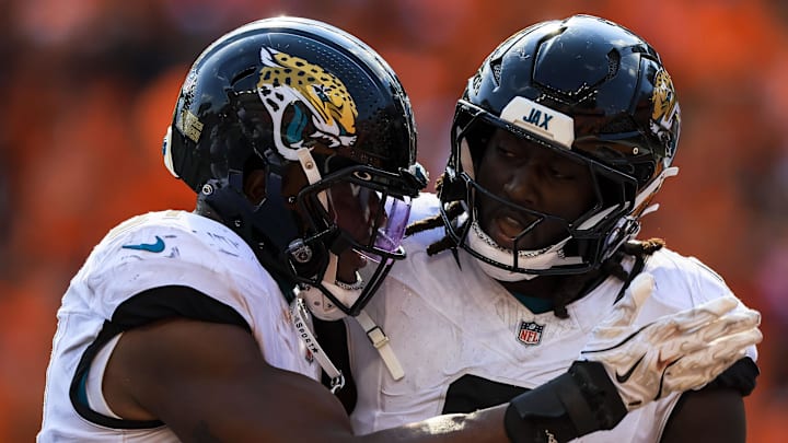 Sep 14, 2025; Cincinnati, Ohio, USA; Jacksonville Jaguars linebacker Devin Lloyd (0) reacts with linebacker Ventrell Miller (51) after intercepting the ball against the Cincinnati Bengals in the second half at Paycor Stadium. Mandatory Credit: Katie Stratman-Imagn Images