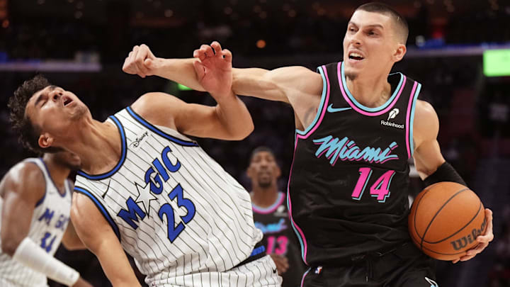 Miami Heat guard Tyler Herro fouls Orlando Magic forward Tristan da Silva