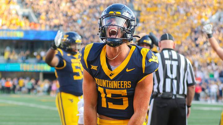 Sep 13, 2025; Morgantown, West Virginia, USA; West Virginia Mountaineers quarterback Scotty Fox Jr. (15) celebrates after a touchdown during the third quarter against the Pittsburgh Panthers at Milan Puskar Stadium. Mandatory Credit: Ben Queen-Imagn Images