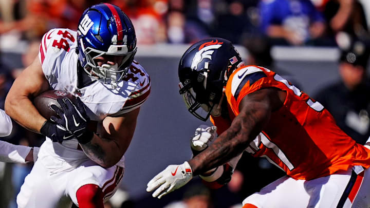Oct 19, 2025; Denver, Colorado, USA; New York Giants running back Cam Skattebo (44) gets hit by Denver Broncos linebacker Dre Greenlaw (57) and cornerback Riley Moss (21). Oct 19, 2025; Denver, Colorado, USA; New York Giants running back Cam Skattebo (44) gets hit by Denver Broncos linebacker Dre Greenlaw (57) and cornerback Riley Moss (21).